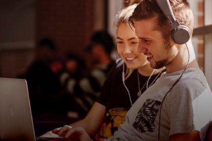 Students watching on laptop screen