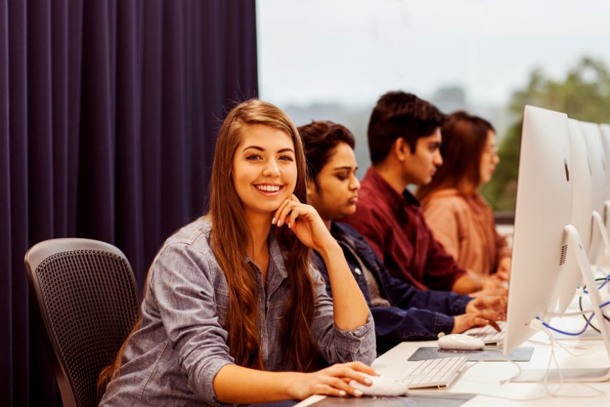 Female student smiling in the computer lab