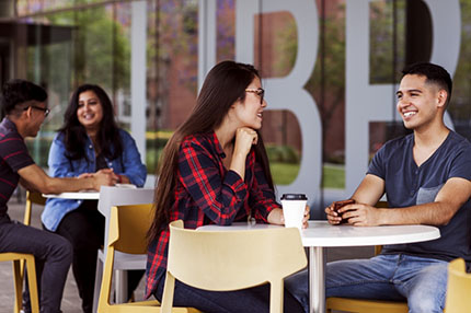 Students sitting outside socialising