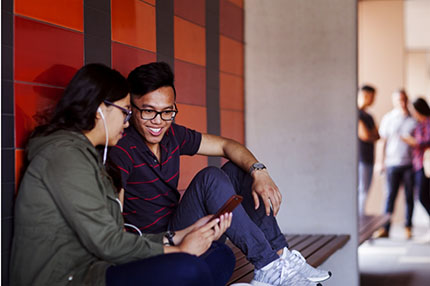 Students sitting wall studying